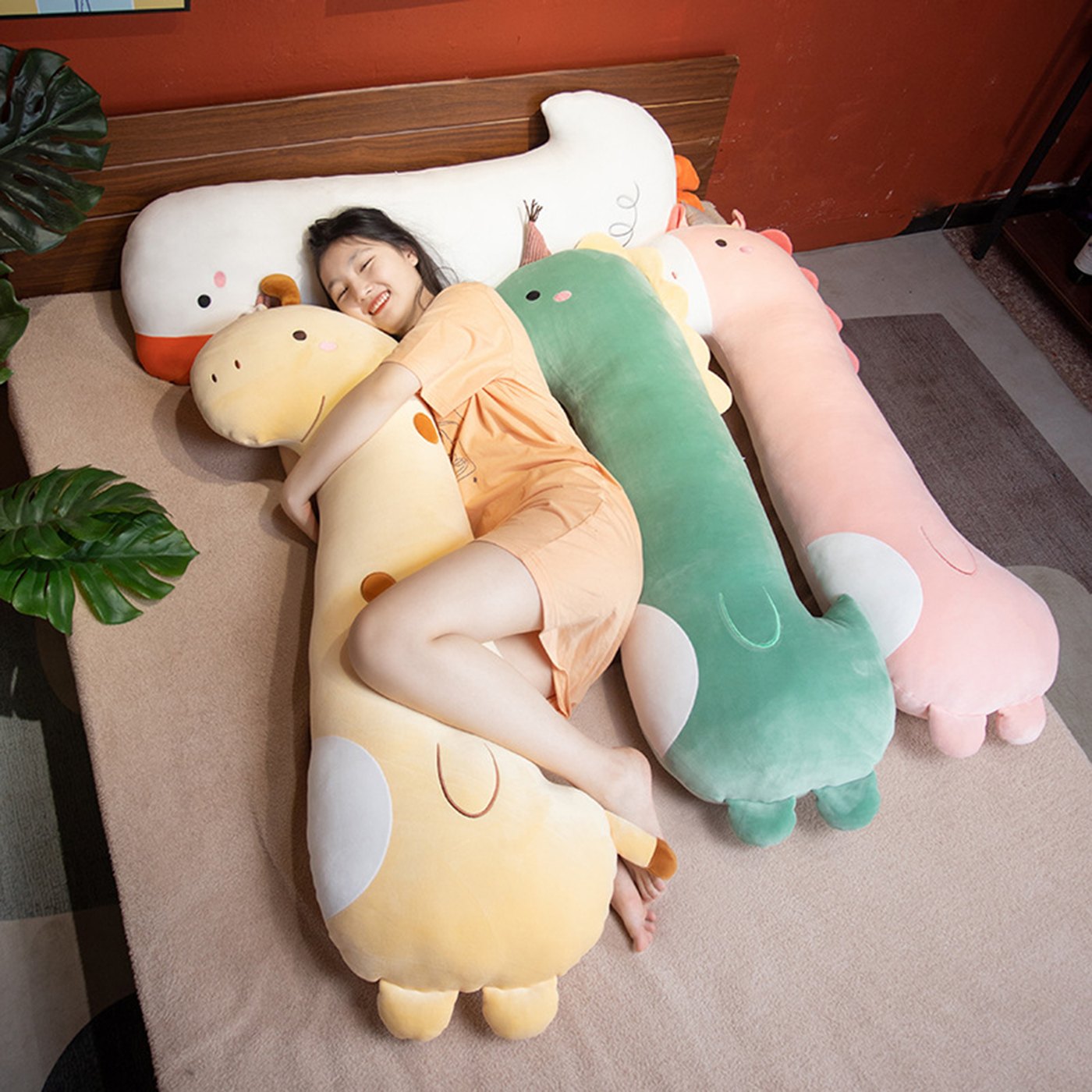 A girl resting on a row of PEACH CAT long plush pillows